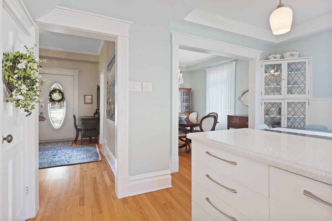 a view of a kitchen and dining room through a doorway,