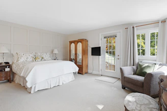 Spacious bedroom with natural light and full accommodation amenities for long stays.