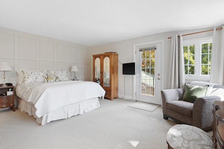 Spacious bedroom with natural light and full accommodation amenities for long stays.