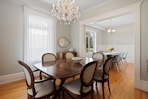a dining room table with chairs and a chandelier