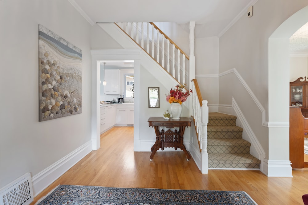 a hallway with a wooden floor and a painting on the wall