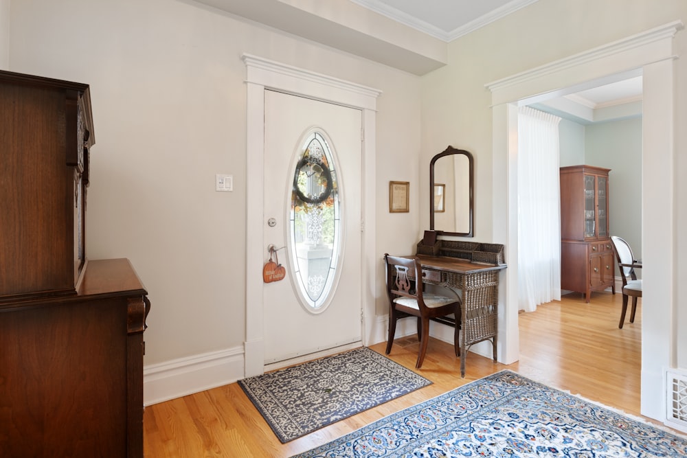 a living room with a piano and a mirror