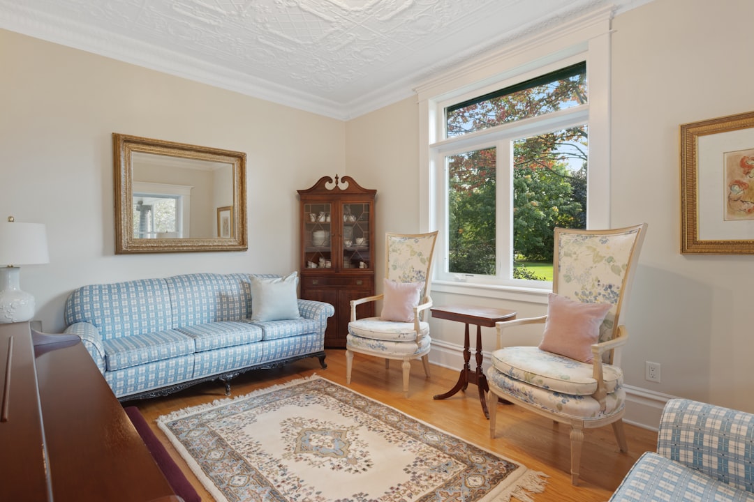 a living room filled with furniture and a large window,