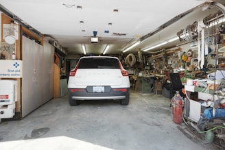 a white car is parked in a garage