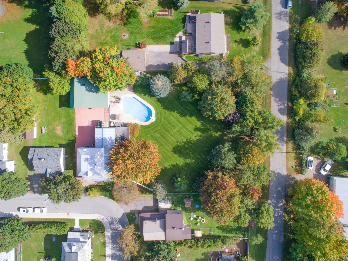 Aerial view of a waterfront residence with pool