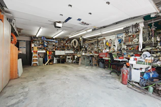 Various construction materials and equipment organized in a bright, clean workshop space.