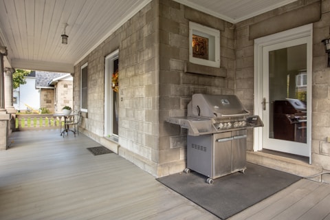 a grill on the front porch of a house