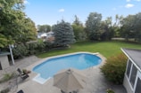 an aerial view of a backyard with a swimming pool