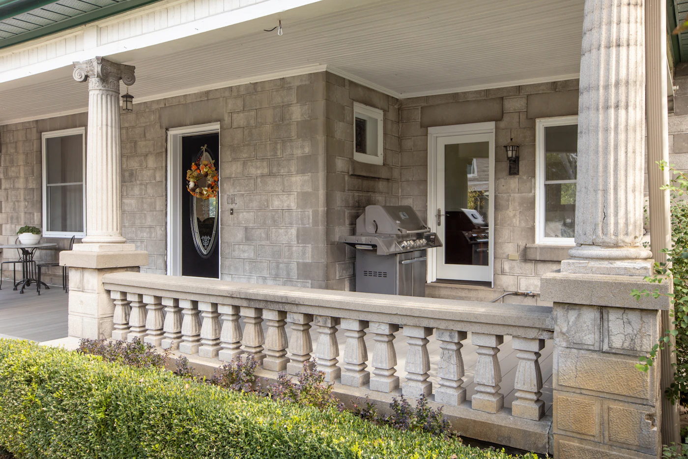 A front porch with columns on a suburban New Jersey–style home