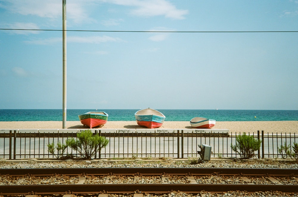 a couple of boats sitting on top of a beach