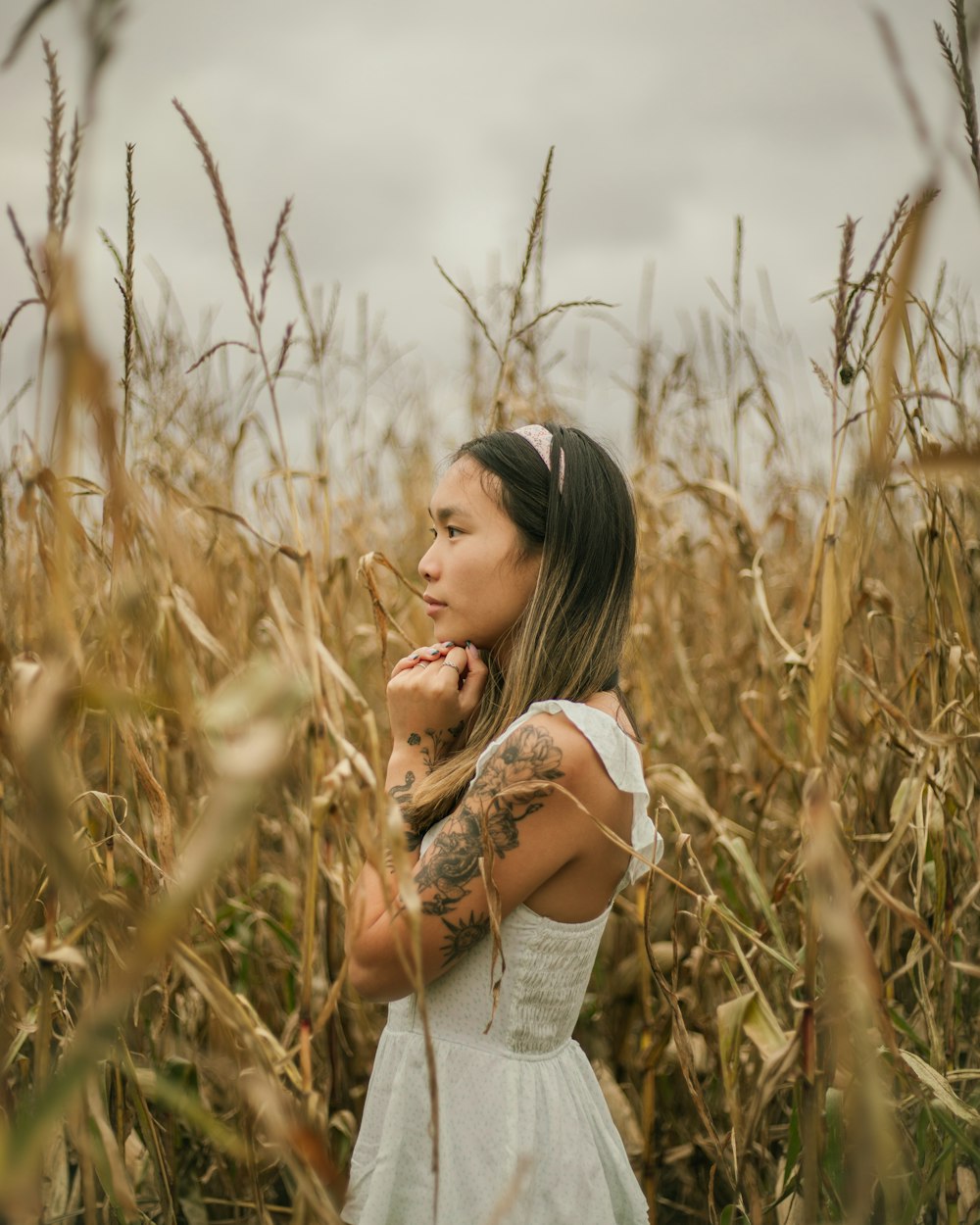 a woman standing in a field of corn