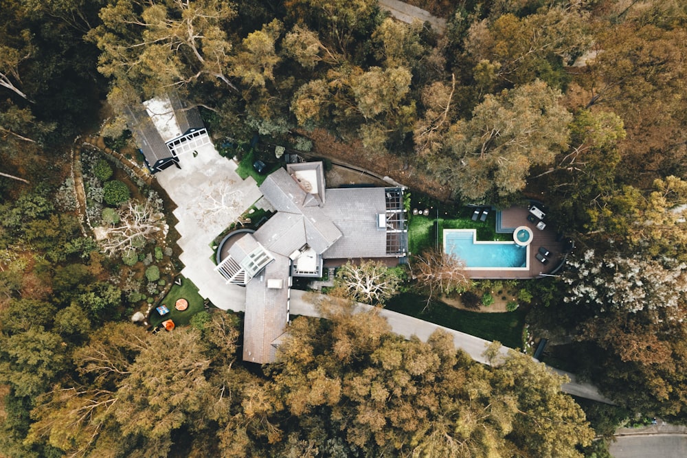 an aerial view of a house surrounded by trees