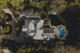 an aerial view of a house in the woods