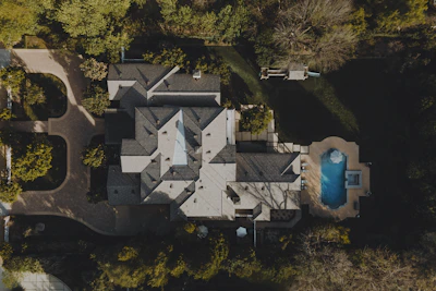 an aerial view of a house in the woods