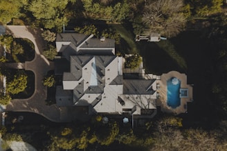 an aerial view of a house in the woods