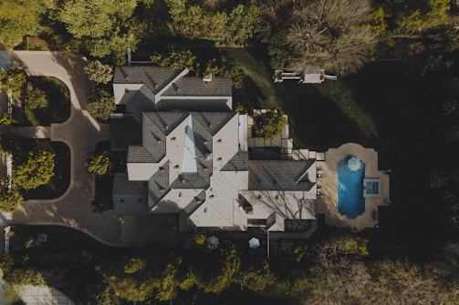 an aerial view of a house in the woods