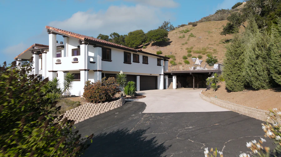 Large white house with a driveway in front of it