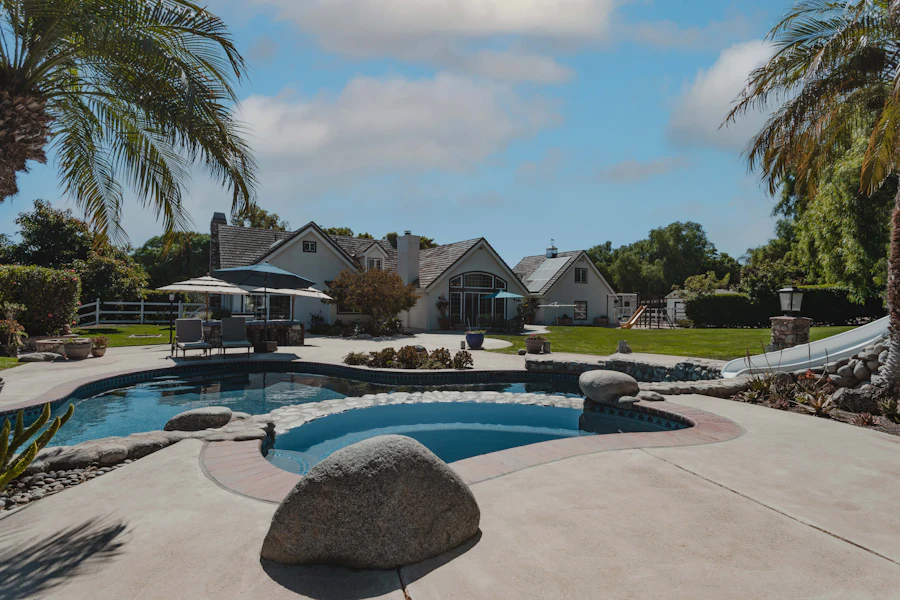 Resort pool concept surrounded by palms and landscaping