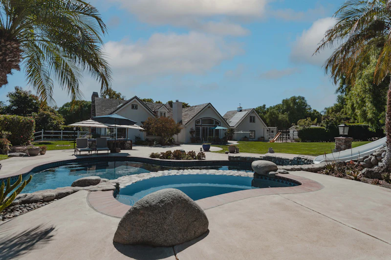 Luxury resort pool with palm trees exterior shot