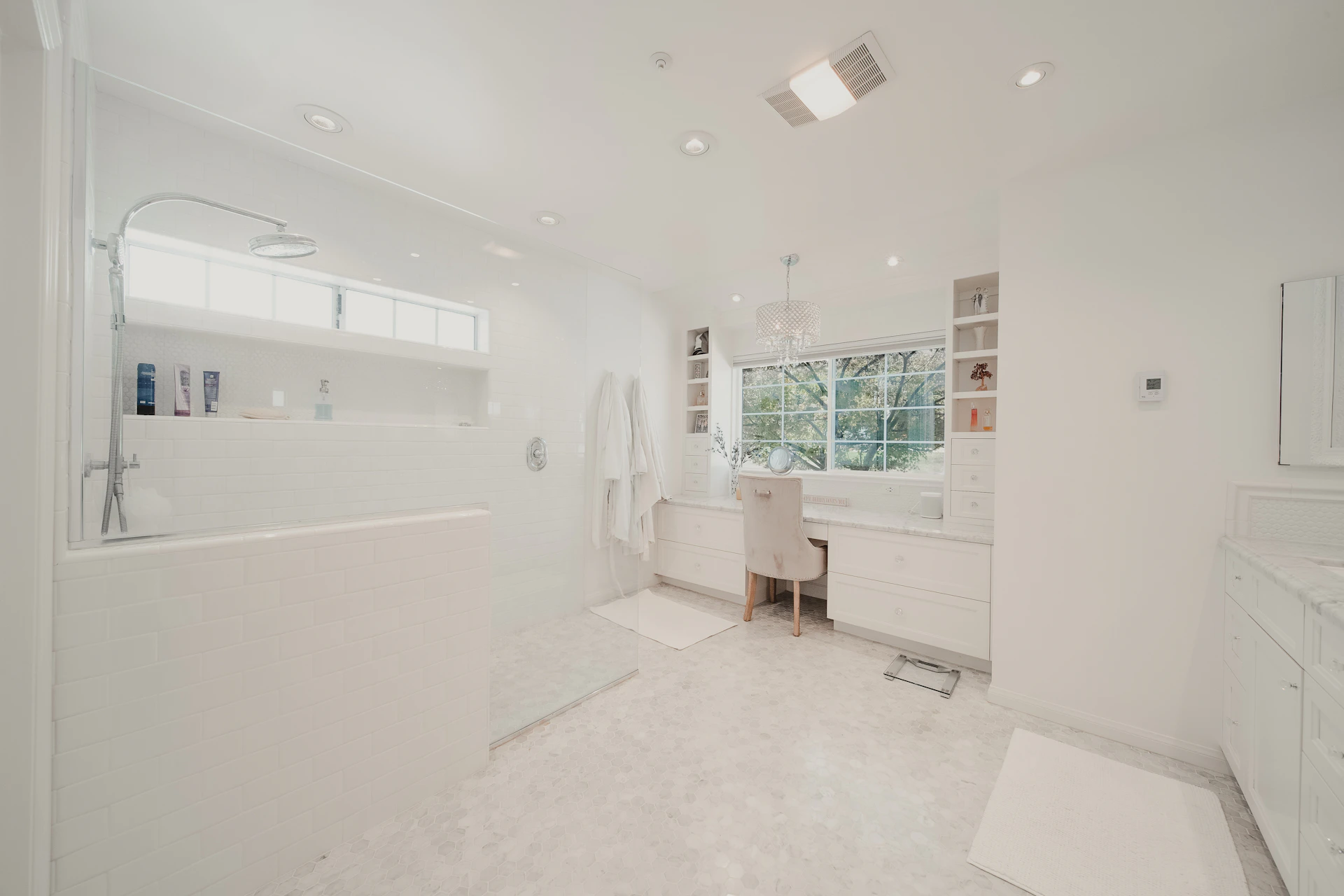a large white bathroom with a tub and sink