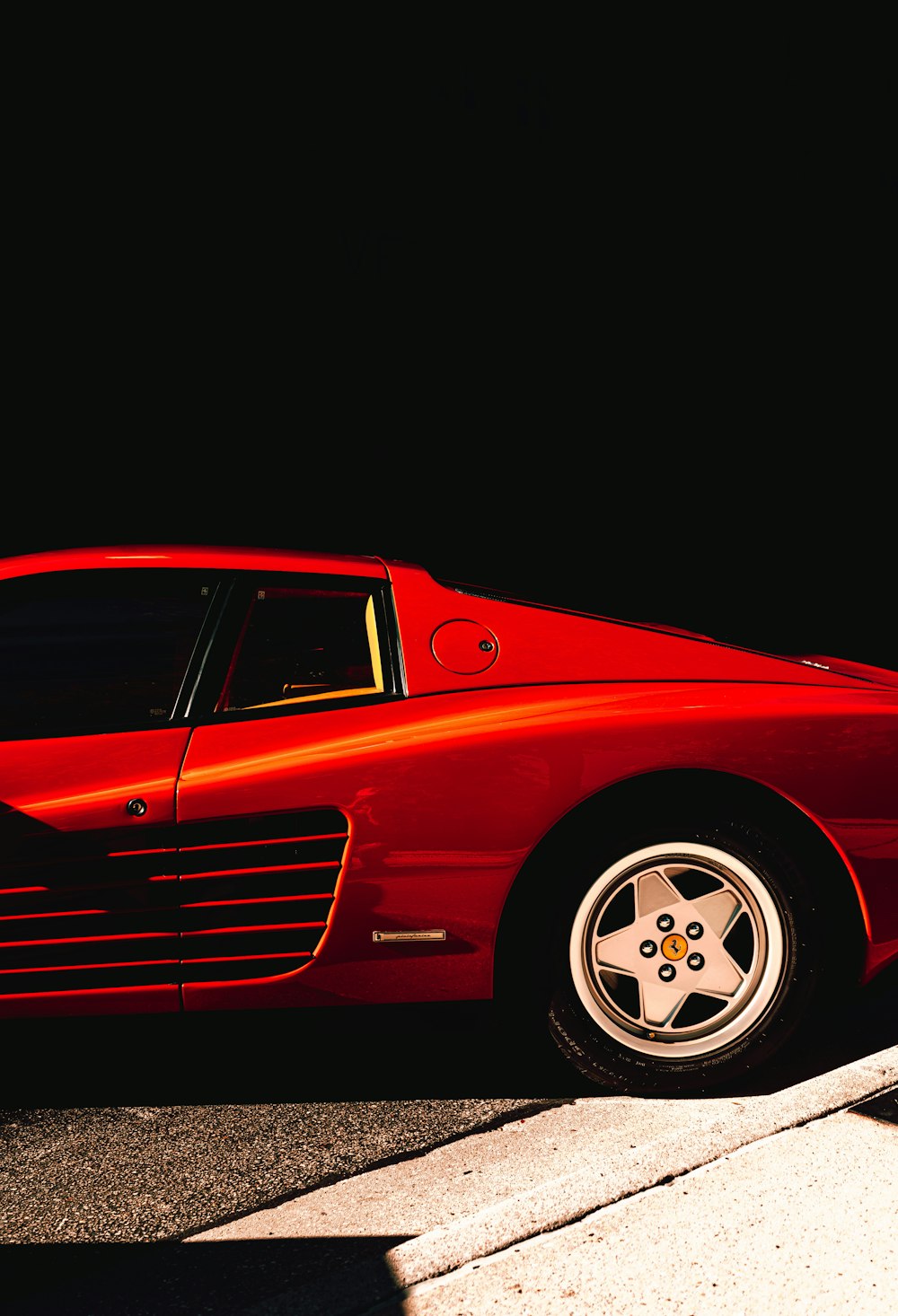 a red sports car parked on the side of the road