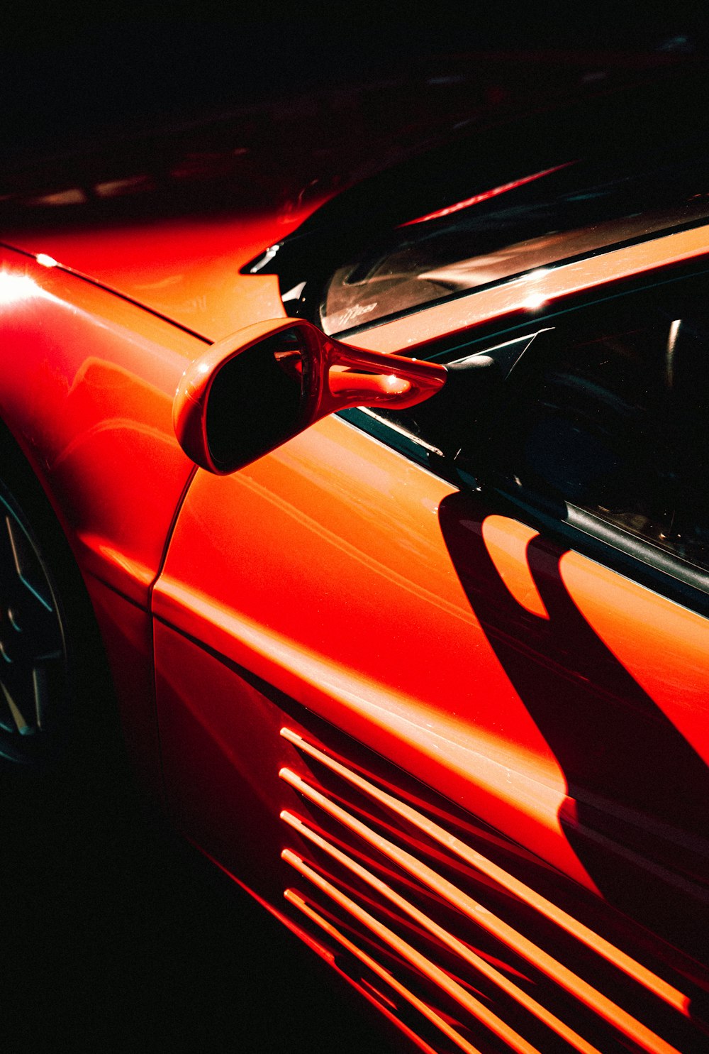 a red sports car parked in a parking lot