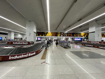 A traveler happily receiving their luggage promptly at the airport baggage claim.