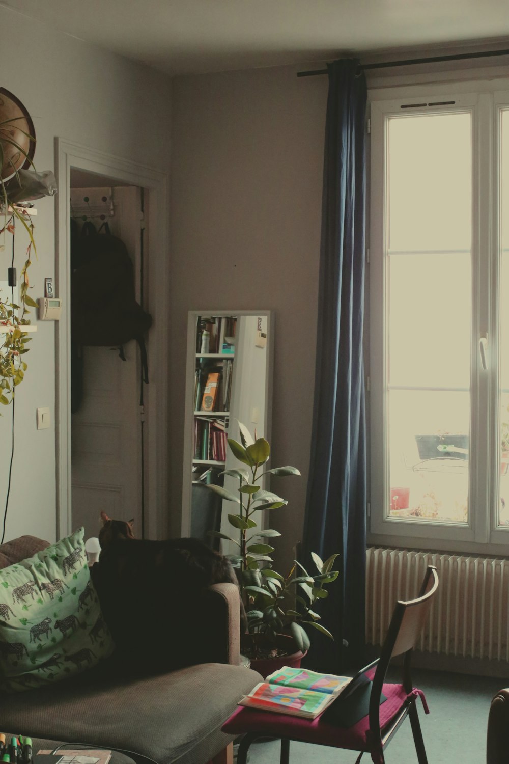 a living room filled with furniture and a window