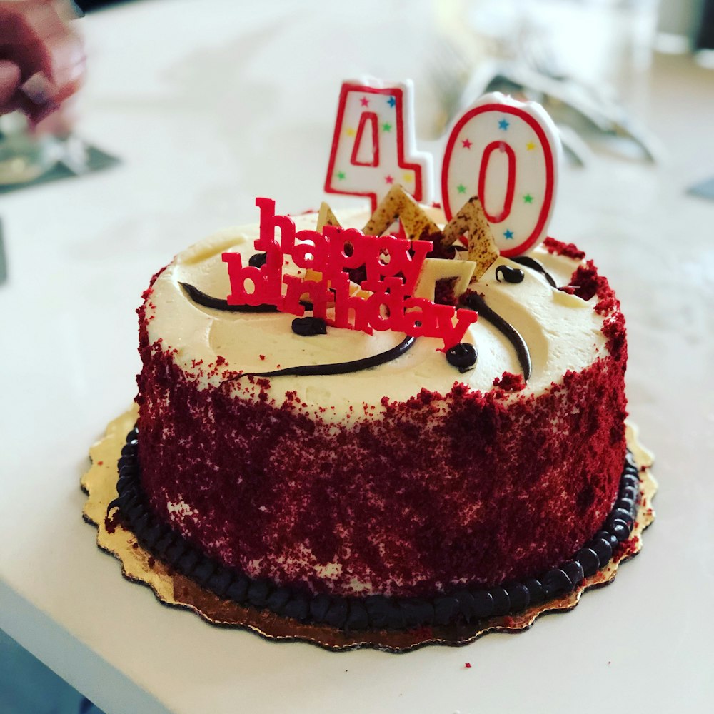 a red velvet birthday cake with white frosting
