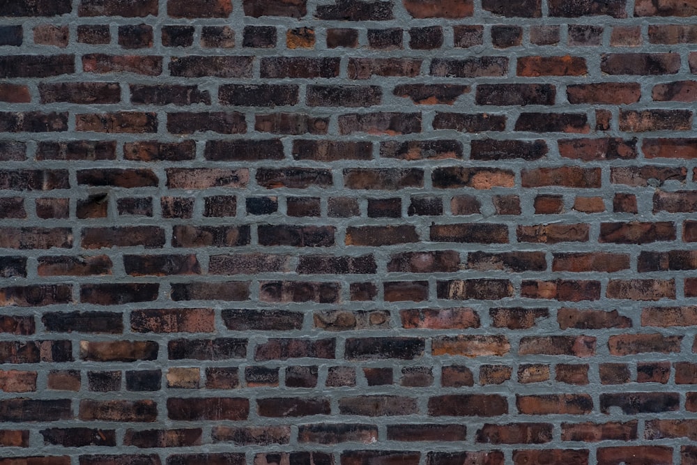 a brick wall is shown with a red stop sign