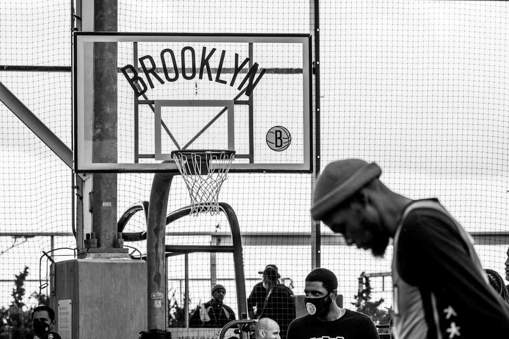 a man standing next to a basketball hoop