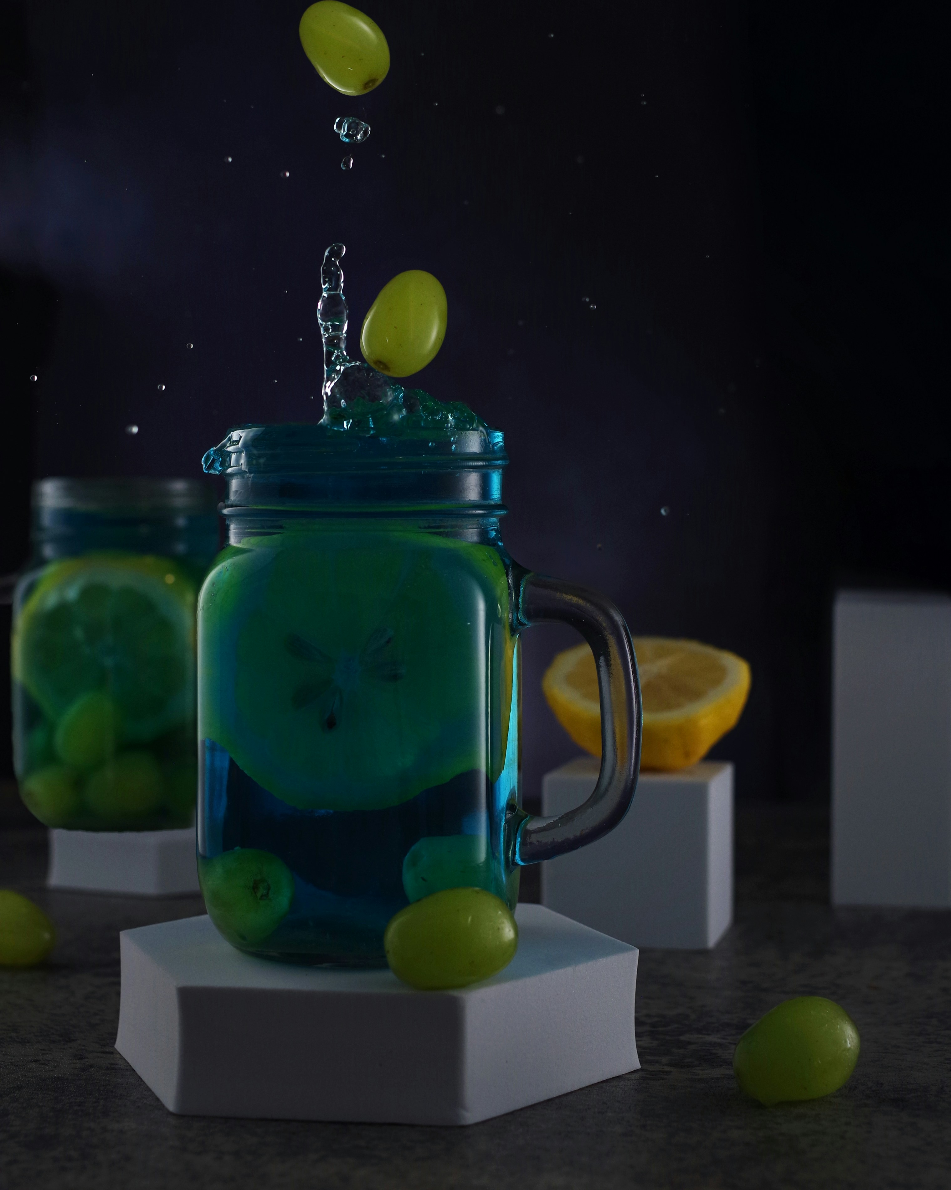 a glass jar filled with lemons and water