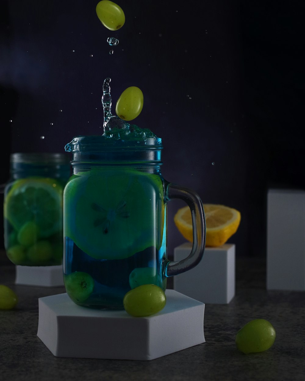 a glass jar filled with lemons and water