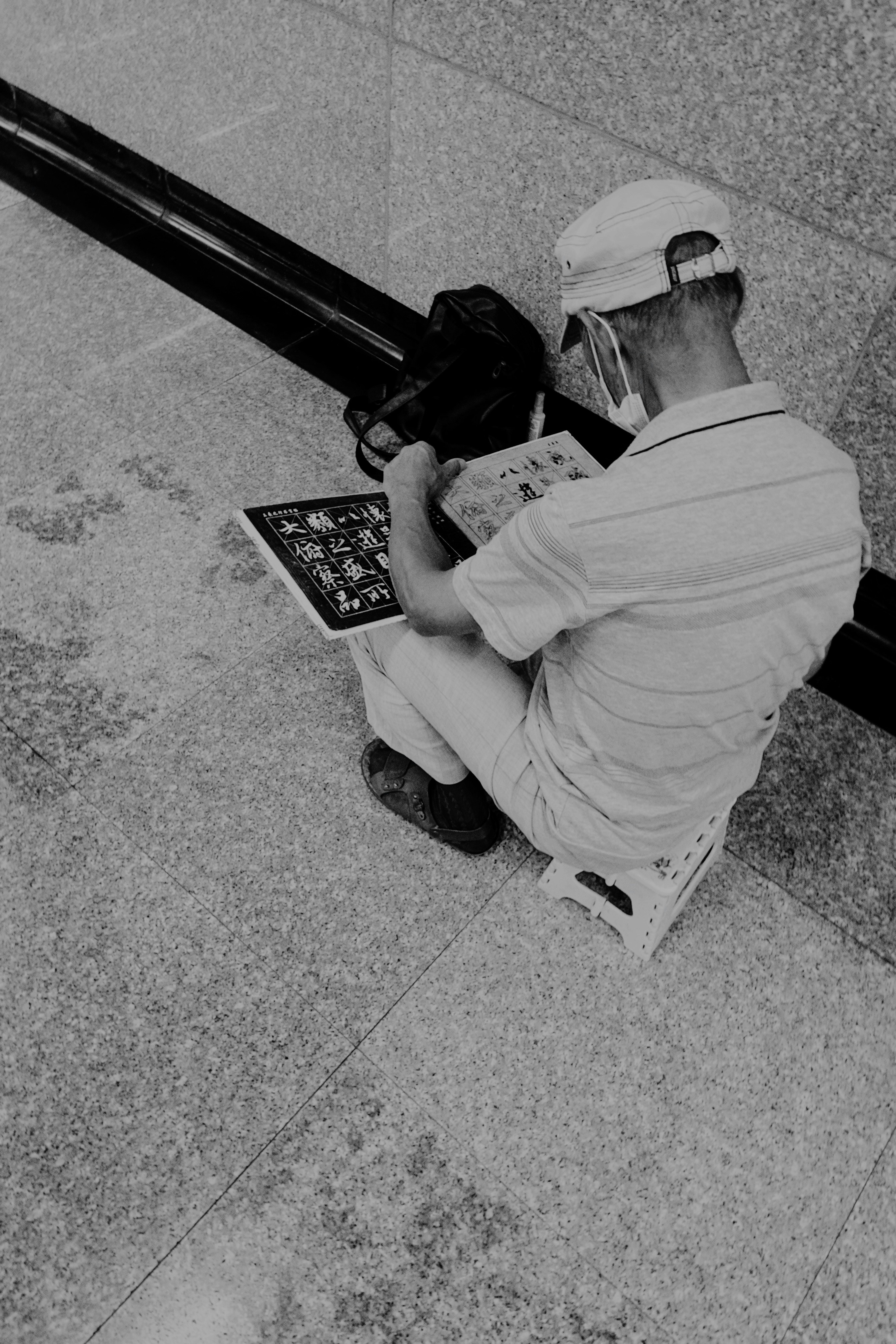 a man sitting on the ground with a laptop