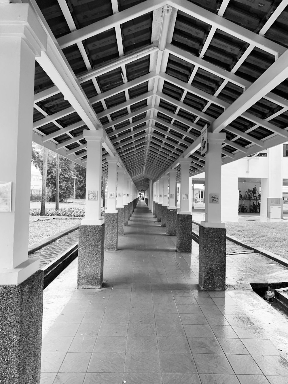 a black and white photo of a walkway