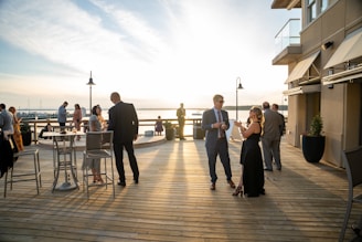 a group of people standing on top of a wooden deck