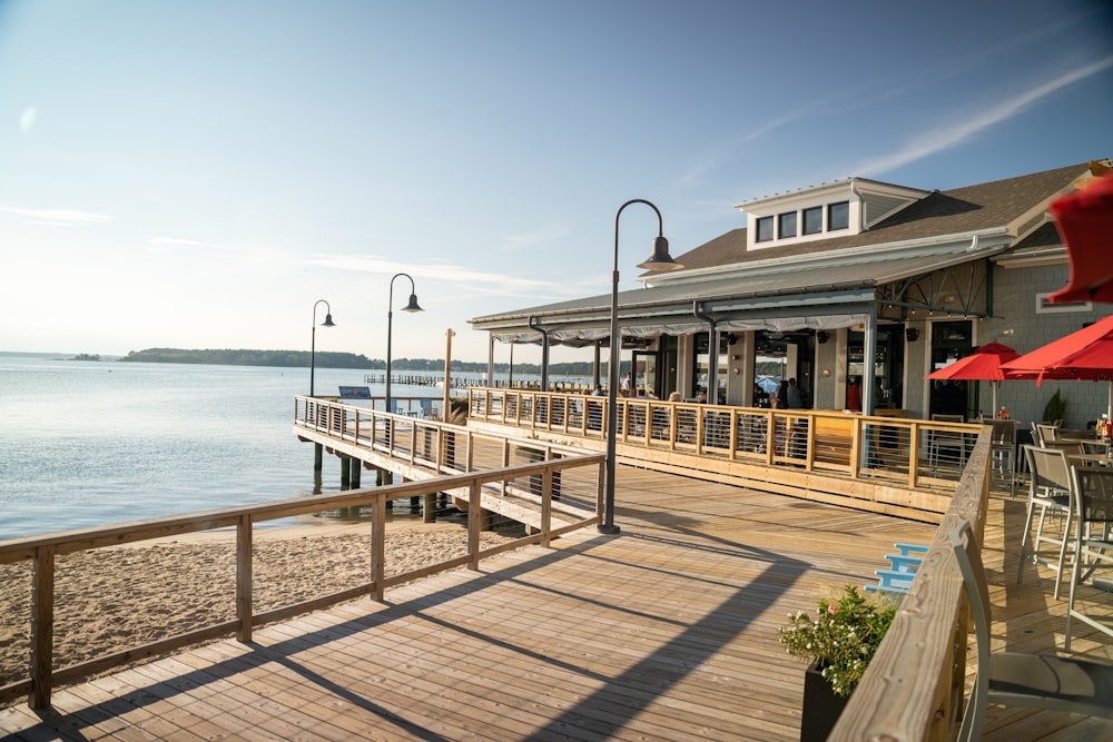 a pier with a restaurant on it next to a body of water