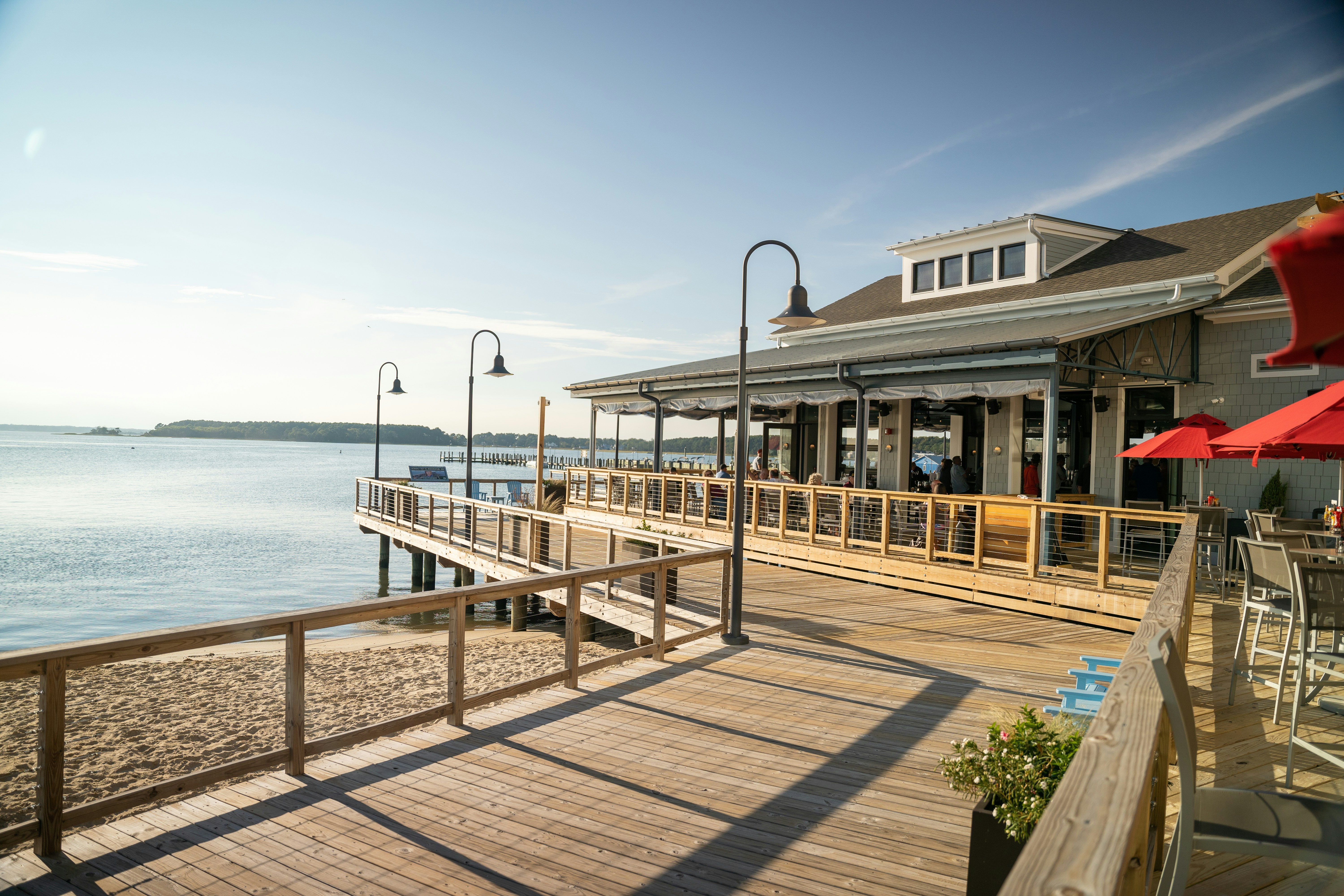 a pier with a restaurant on it next to a body of water