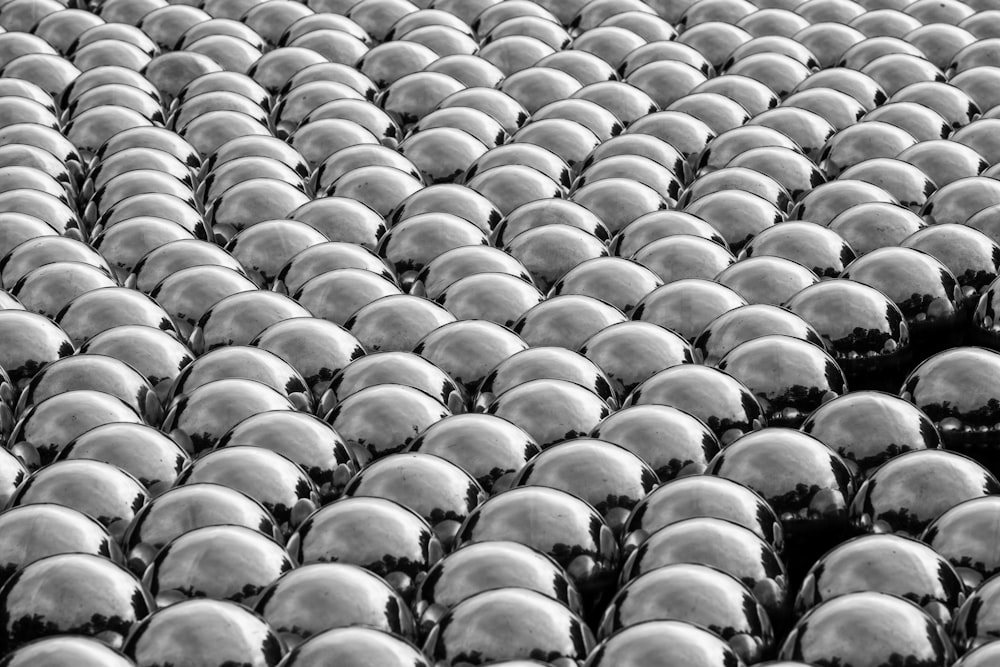 a black and white photo of a large group of helmets