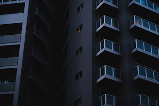a tall building with balconies and balconies lit up at night