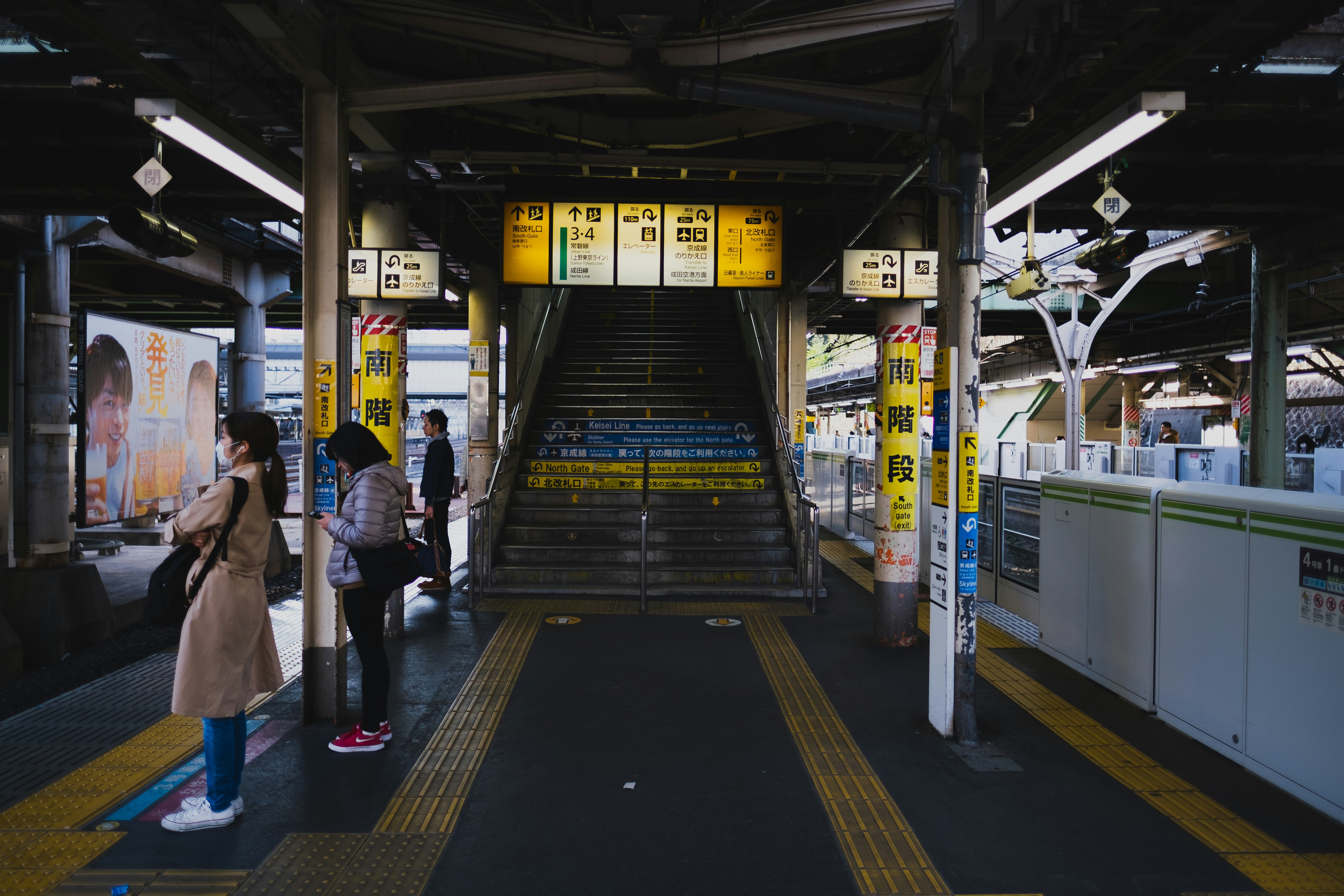a group of people standing in a train station