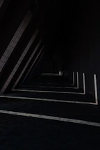a row of black and white lines next to a building