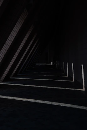 a row of black and white lines next to a building