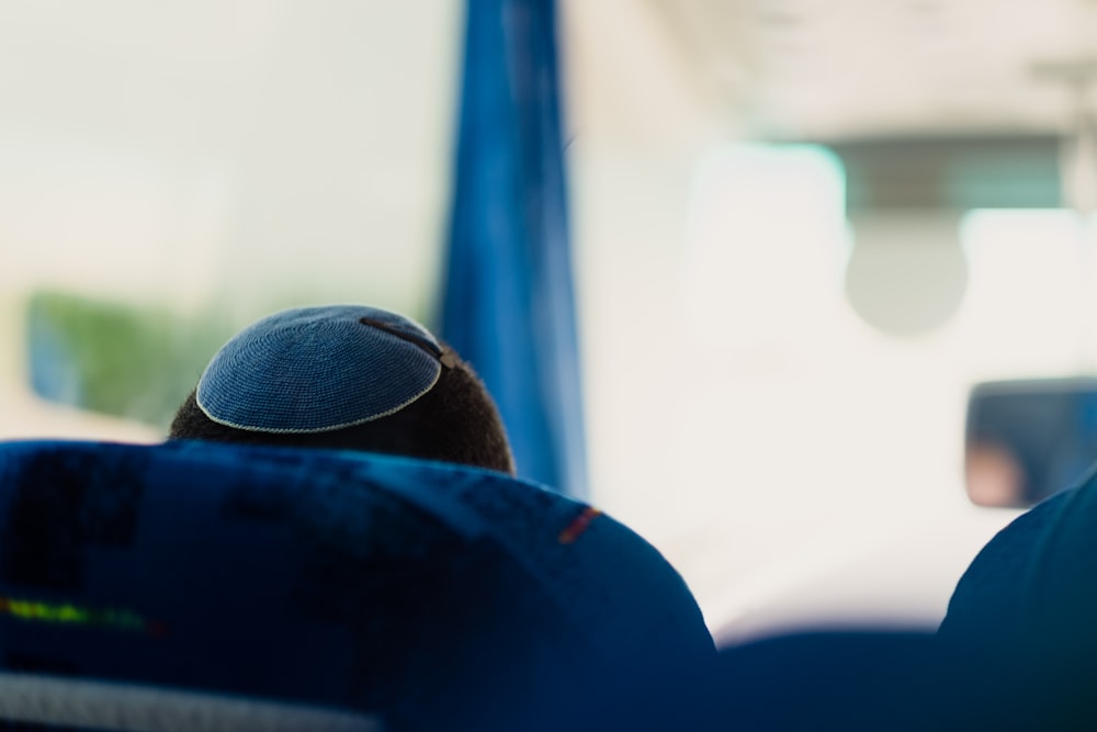 the back of a person's head sitting on a bus