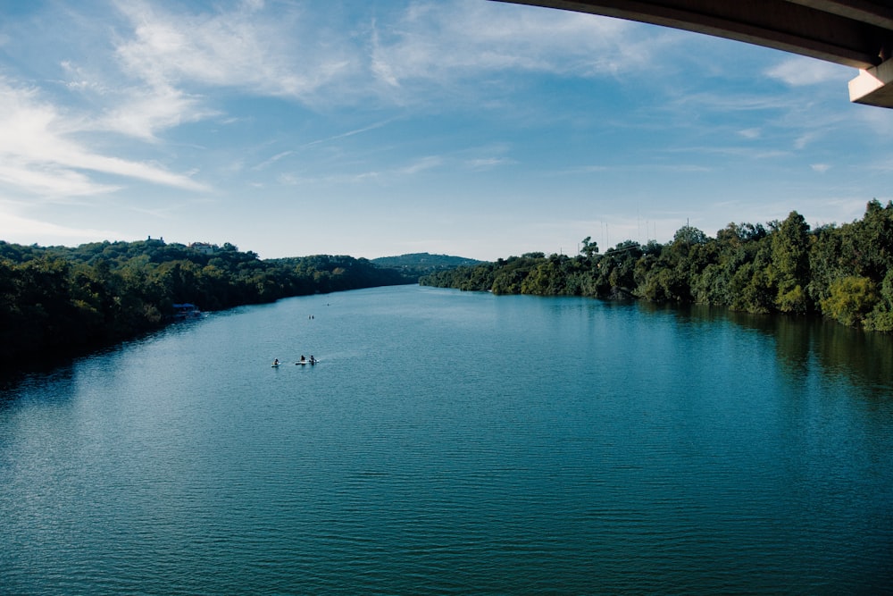 two people in a boat on a large body of water