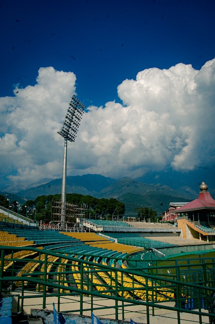 a baseball field with a tall metal pole