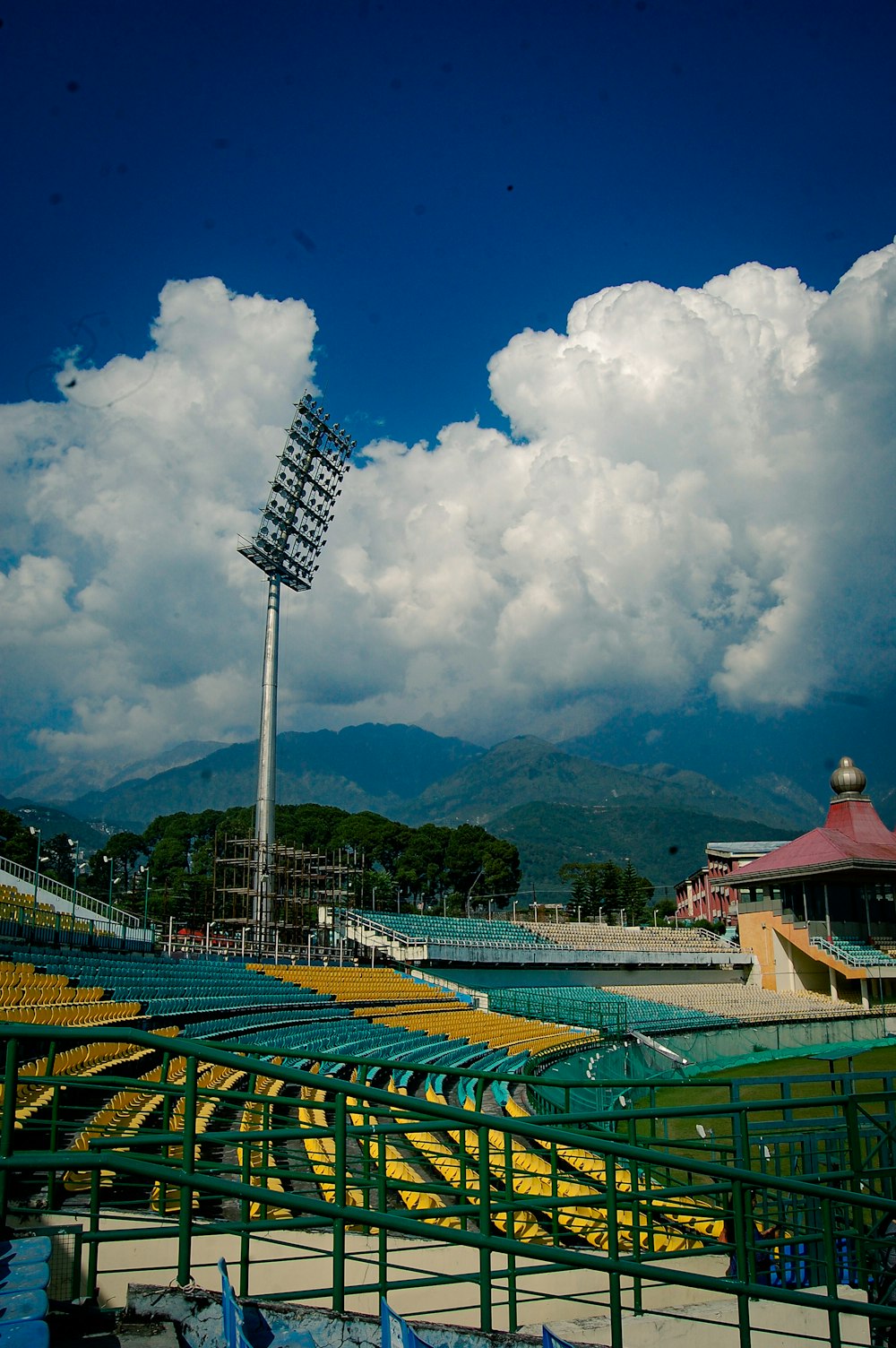 a baseball field with a tall metal pole