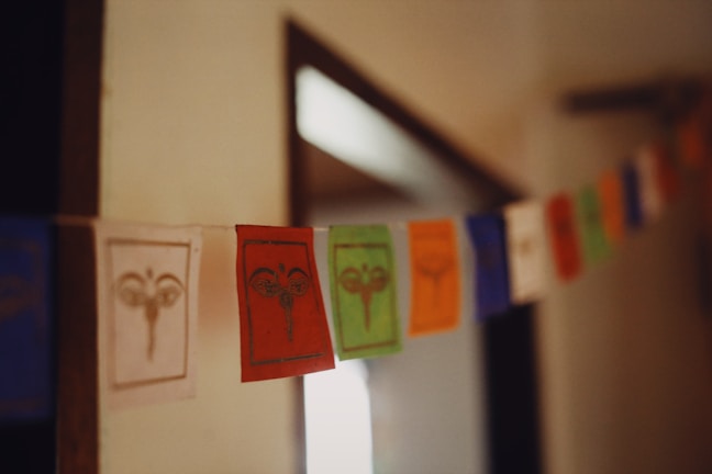 Artisan hands creating a prayer flag, embodying devotion and craftsmanship.