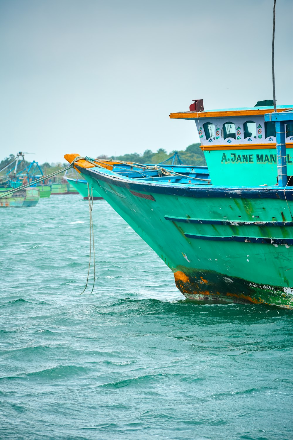 a large green boat in the middle of a body of water