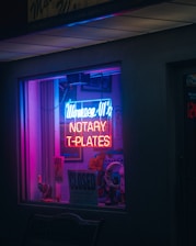 a neon sign in the window of a store